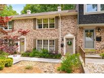 Charming brick townhome featuring a cozy front entrance and well-maintained landscaping at 2349 Northlake Ne Ct, Atlanta, GA 30345