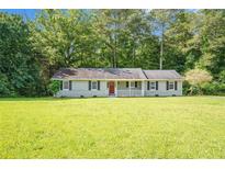 Charming single-story home with a well-manicured lawn and welcoming front porch at 2895 Fairview Rd, Covington, GA 30016