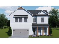 Charming two-story home featuring white siding, brick accents, a gray garage door, and a beautifully landscaped front yard at 408 Westmarch Cir, Loganville, GA 30052