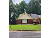 Charming brick home with a well-maintained front yard and mature trees at 6210 Douglas Manor Ct, Douglasville, GA 30134