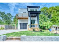 New construction home boasts a modern design with a second story balcony and a covered front porch at 862 Hobson Street Southwest Sw St, Atlanta, GA 30310