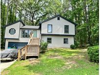 Charming two-story home featuring a front porch with wood accents and a serene wooded surrounding at 2816 Quinbery Dr, Snellville, GA 30039