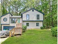 Charming two-story home features a well-manicured lawn, inviting entrance, and attached garage at 2816 Quinbery Dr, Snellville, GA 30039