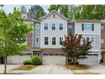 Charming townhome featuring a gray exterior with a brick facade and a one-car garage at 2817 White Oak Ln, Decatur, GA 30032