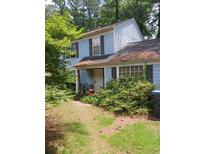 Light blue home with a covered front porch and an overgrown yard at 2939 Carrie Farm Nw Rd, Kennesaw, GA 30144