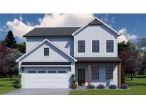Charming two-story home featuring white siding, a covered front porch, and an attached two-car garage at 702 Bristol Dr, Loganville, GA 30052