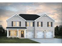Charming two-story home with a brick facade, black roof, and a well-manicured front lawn and a two car garage at 1673 Fuma Leaf Way, Mcdonough, GA 30253