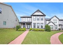 Charming two-story home featuring a well-manicured lawn and inviting brick pathway at 3658 Madison St, College Park, GA 30337