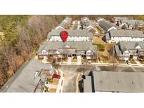 Aerial view of townhomes with brick and siding exteriors, garages, and well-maintained landscaping at 2555 Flat Shoals Road Rd # 1104, College Park, GA 30349