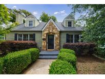 Charming home featuring a stone accented doorway, tidy hedges, and a well-manicured front lawn at 2668 Jefferson Ter, East Point, GA 30344