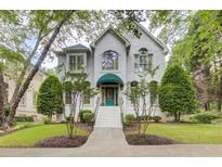 Elegant home with a well-manicured front yard, white facade, and a charming entrance with an awning at 42 Greenland Trce, Atlanta, GA 30342