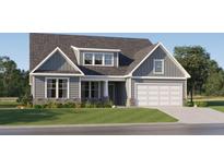 Charming two-story home featuring a two-car garage, stone accents, and manicured lawn at 8 Unicoi Trl, Sharpsburg, GA 30277
