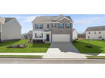 Beautiful new two-story home with a spacious lawn and a two-car garage at 174 Aster Avenue, Locust Grove, GA 30248