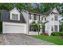 Charming two-story white home with black shutters, manicured lawn, and a two-car garage at 470 Piney Sw Way, Atlanta, GA 30331