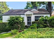 Charming home featuring a lush, landscaped front yard and a freshly painted exterior at 522 Trabert Nw Ave, Atlanta, GA 30309