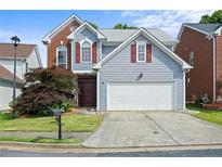 Charming two-story home featuring brick and siding accents with a well-manicured front yard at 2890 Winterhaven Ct, Atlanta, GA 30360