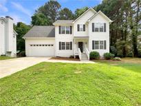Charming two-story home featuring a well-manicured lawn, attached garage, and traditional architectural details at 6001 Deer Springs Nw Ln, Acworth, GA 30101