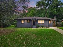 Charming single-story home featuring a well-manicured lawn and freshly painted exterior at 1643 Flintwood Se Dr, Atlanta, GA 30316