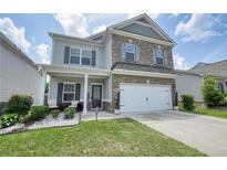 Charming two-story home with a brick and siding exterior, well-manicured lawn, and attached two-car garage at 5322 Burrus Sw Ln, Mableton, GA 30126
