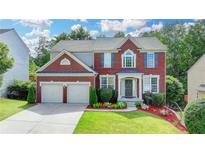 Beautiful two-story brick home with a well-manicured lawn and a two-car garage at 475 Bayswater Way, Suwanee, GA 30024