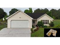 Charming single-story home featuring a two-car garage and well-maintained landscaping at 210 Overview Ct, Villa Rica, GA 30180