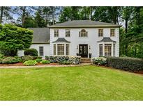 Charming two-story traditional home with manicured lawn, lush landscaping, and stately front entrance at 3275 Lord N Lady Ln, Alpharetta, GA 30022