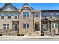 Attractive townhome exteriors with stone accents and welcoming front entrances at 178 Munira Sw Ln, Atlanta, GA 30331