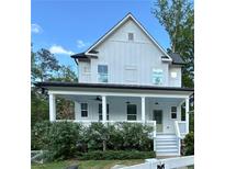 Charming two-story home with a welcoming front porch, white siding, and well-maintained landscaping at 3240 Columbia Oaks Way, Decatur, GA 30032