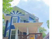 Blue two-story home featuring a decorative sunburst design and welcoming front porch at 1454 Rome Nw Dr, Atlanta, GA 30314
