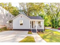 Charming light blue home with a cozy front porch and well-maintained landscaping at 2876 Randall St, East Point, GA 30344