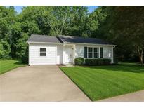 Charming single-story home boasts a well-manicured lawn and tidy landscaping at 3909 S Creek Ct, Stone Mountain, GA 30083