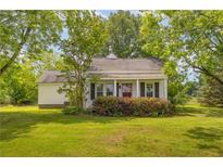 Charming home featuring a covered front porch and a well-manicured lawn at 1730 Lee Peters Rd, Loganville, GA 30052