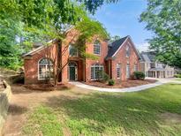 Charming two-story brick home with a landscaped yard and arched windows at 3832 Cherry Ridge Blvd, Decatur, GA 30034