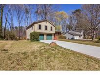 Charming two-story home featuring a two-car garage and a spacious front yard with a long driveway at 1312 Brandl Dr, Marietta, GA 30008