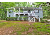 Charming front exterior with covered porch and well-maintained landscaping at 476 Cody Ln, Douglasville, GA 30134