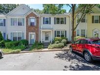 Charming townhome with light siding, blue shutters, and well-maintained landscaping at 10900 Wittenridge Dr # C7, Alpharetta, GA 30022
