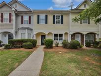 Charming townhome with a landscaped front yard, inviting walkway, and classic architectural details at 25 Timber Ridge Dr, Cartersville, GA 30121