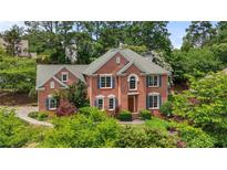 Charming brick home with blue shutters and lush landscaping at 1850 Mallard Lake Dr, Marietta, GA 30068