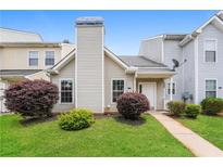 Charming townhouse with a well-maintained lawn and manicured bushes at 5867 Trent Walk Dr, Lithonia, GA 30038