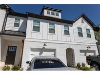 Charming townhouse with white brick and siding and attached garages at 82 Auburn Run Ln, Auburn, GA 30011