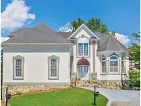 Charming home featuring a stone accent base, gray roof, and meticulously maintained lawn at 4770 Powers Park Ne Ct, Marietta, GA 30067