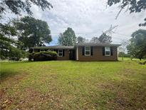 Charming single-story home features a well-maintained lawn and a cozy facade with black shutters at 6668 Prinston Cir, Douglasville, GA 30135