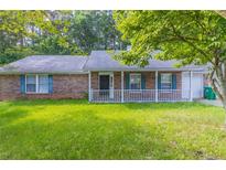 Charming brick home with a well-maintained lawn and inviting front porch, perfect for relaxing and enjoying the outdoors at , Lithonia, GA 30038