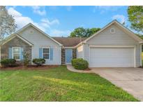 Charming single-story home with stone accents, blue shutters, and a well-manicured lawn at 1011 Riverclift Dr, Covington, GA 30016