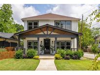 Charming two-story home with modern farmhouse design, inviting front porch, and well-maintained landscaping at 1354 Mcpherson Se Ave, Atlanta, GA 30316