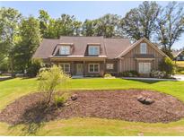 Charming home featuring a manicured front yard, dormers, and siding at 90 Alcovy Reserve Way, Covington, GA 30014