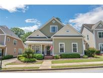 Charming two-story home with a well-manicured lawn, lush landscaping and inviting front porch at 125 Rabbits Run, Fayetteville, GA 30215