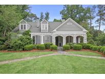Charming two-story home with stone accents, inviting walkway, and lush landscaping at 635 Wilson Nw Rd, Atlanta, GA 30318