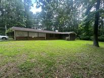 Traditional brick home nestled in a wooded lot with a spacious front yard at 2237 Walt Stephens Rd, Jonesboro, GA 30236