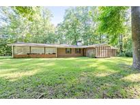 Charming single-story brick home with a spacious yard, perfect for outdoor activities and relaxation at 2237 Walt Stephens Rd, Jonesboro, GA 30236